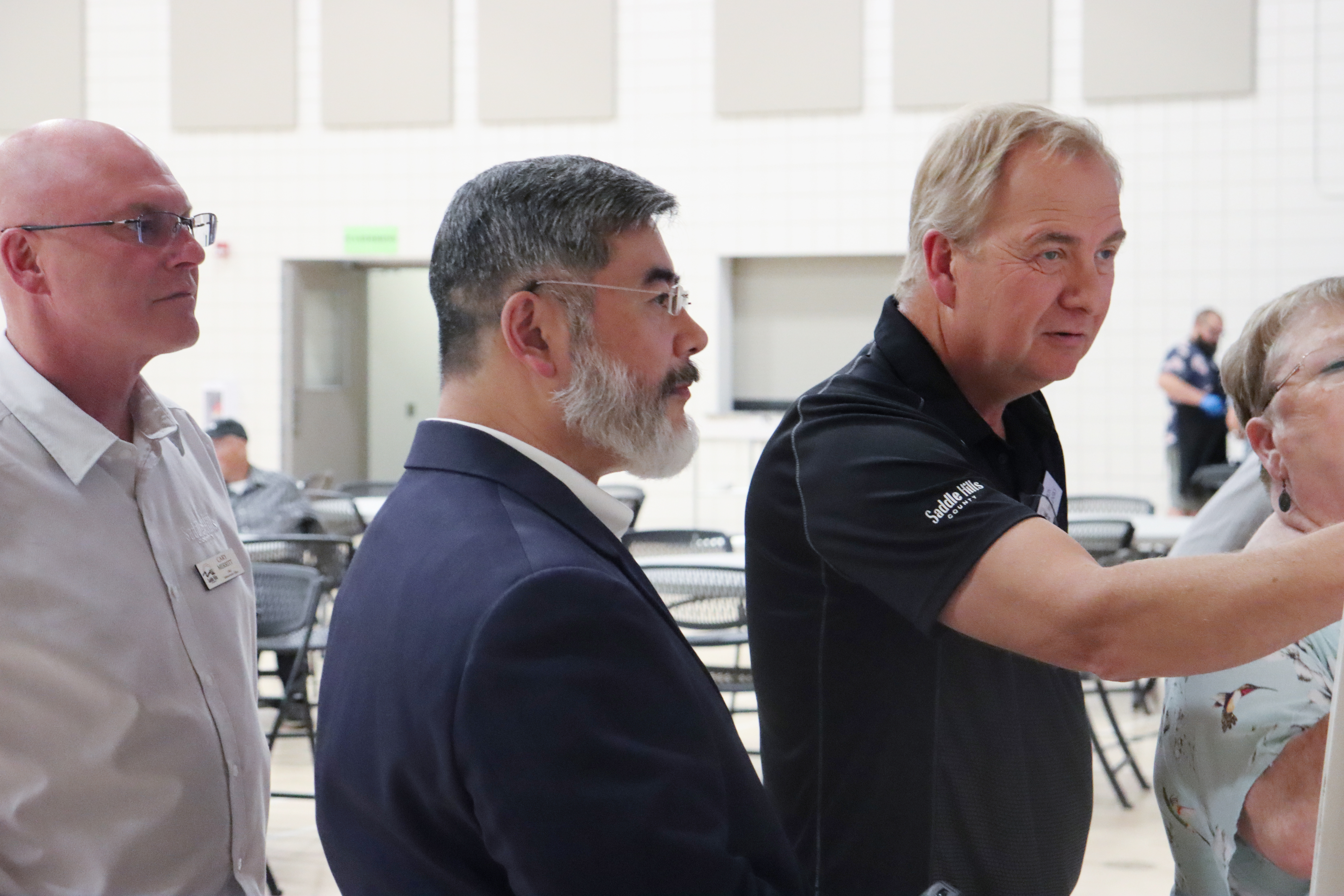 Image of officials helping woman at Open House