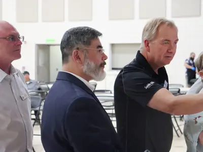 Image of officials helping woman at Open House