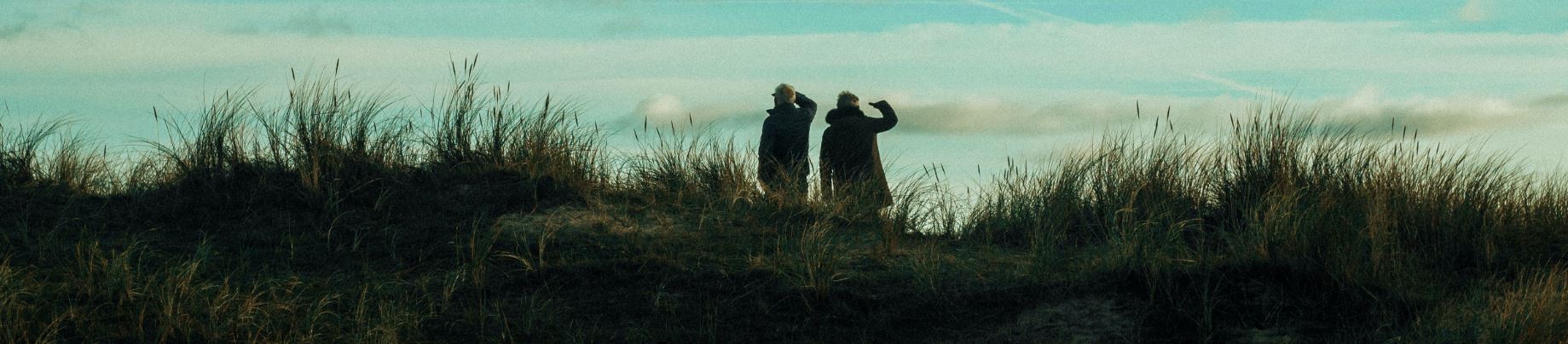 Image of two people in a field dreaming